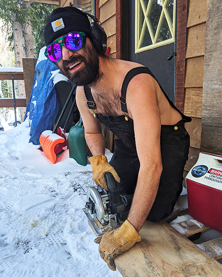 lifestyle - guy with power saw and 6 to midnight