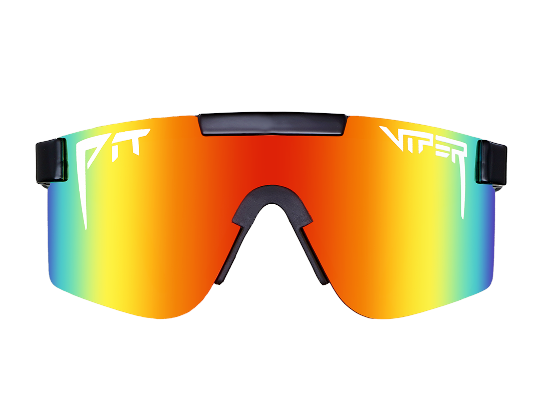 Man wearing The Mystery Polarized sunglasses with sleek black frame and mirrored lenses against a clear sky background