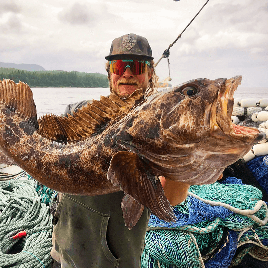 / Polarized Orange | Man holding a large fish wearing Pit Viper Sunglasses