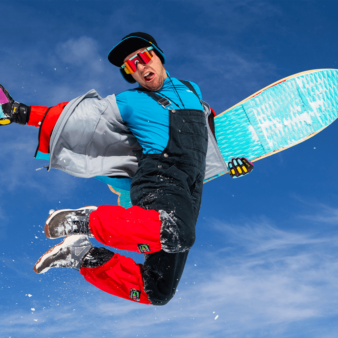 / Polarized Orange | Man jumping holding a snowboard wearing Pit Viper Sunglasses