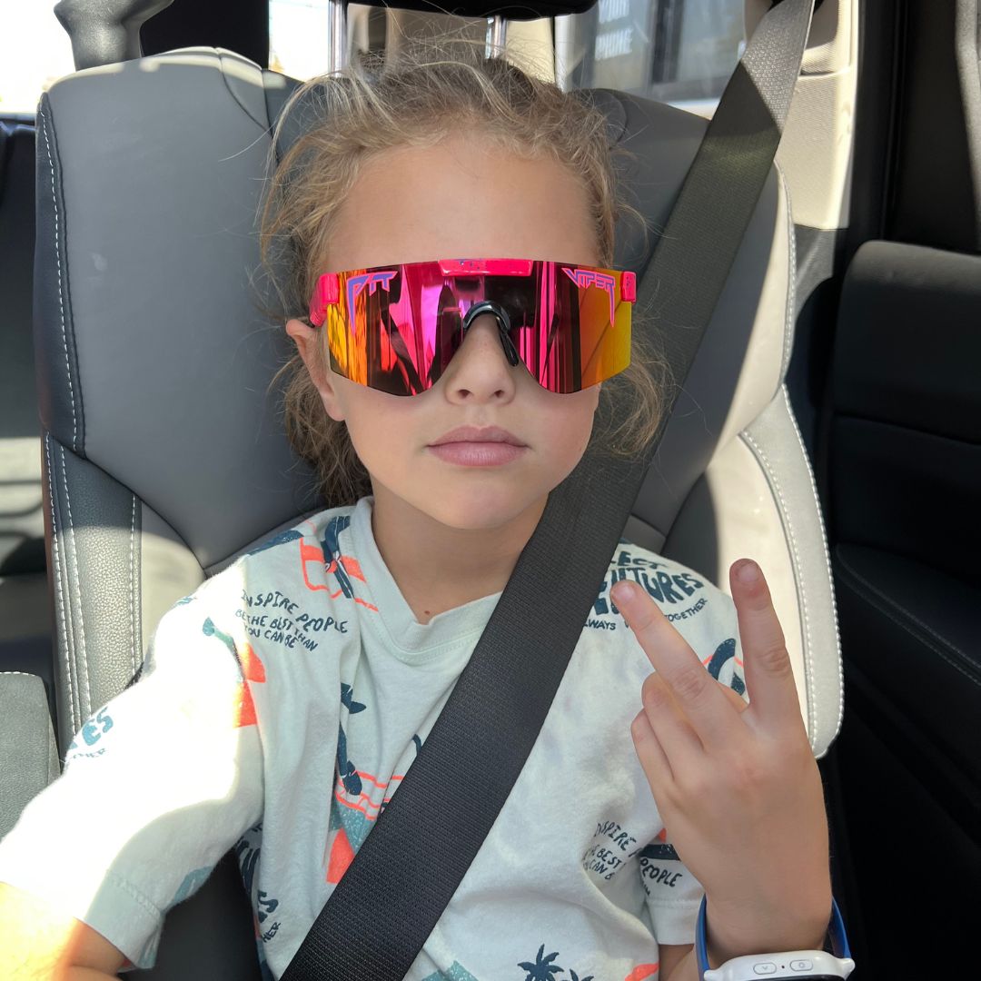 / Rainbow | Kid in a car wearing The Radical XS from Pit Viper Sunglasses