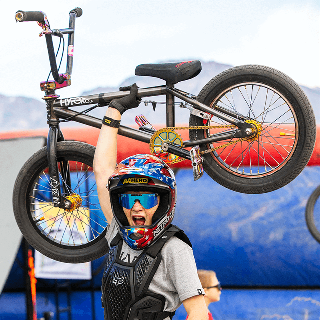 / Blue | Kid holding a BMX Bike wearing The Midnight XS from Pit Viper Sunglasses