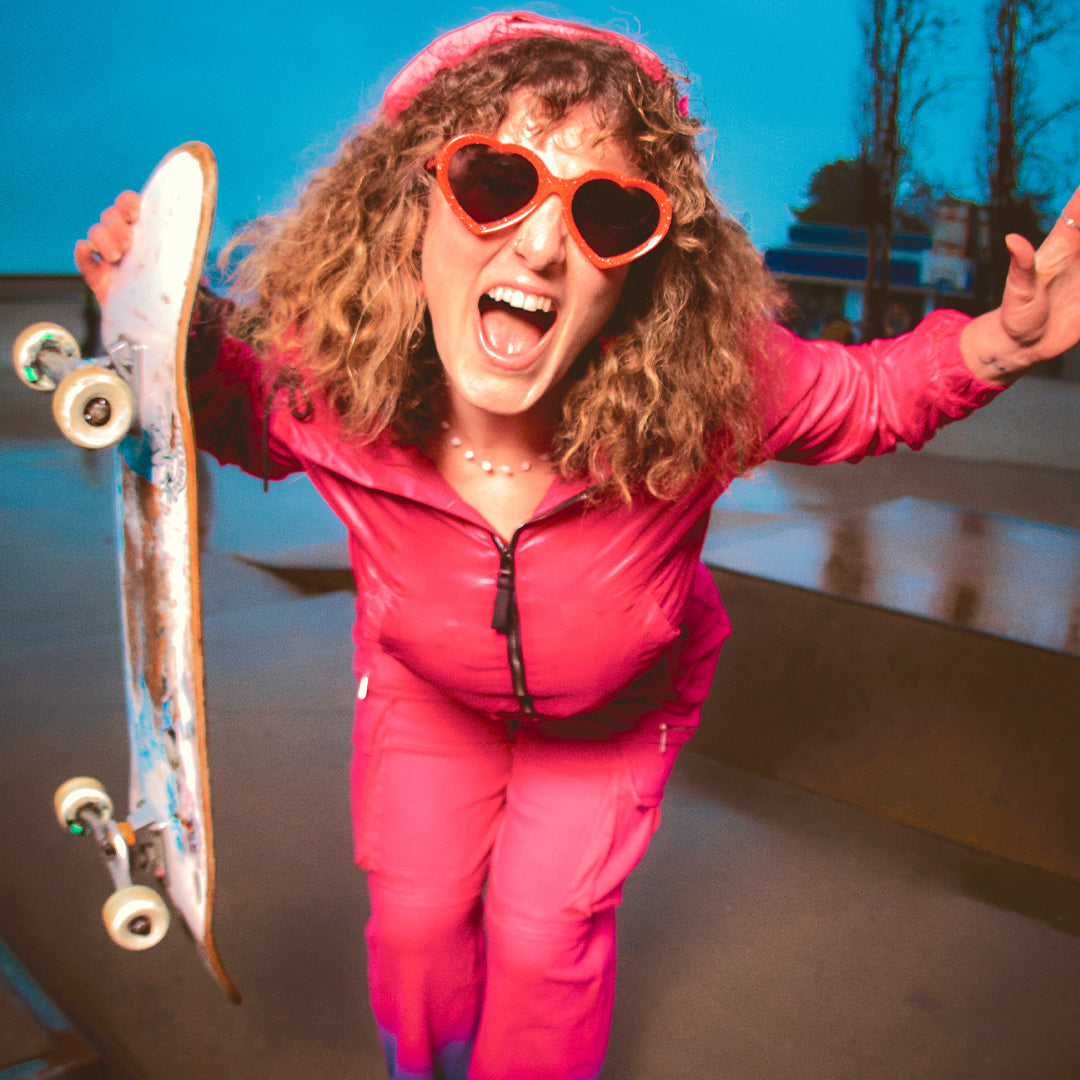 / Smoke | Woman holding a skateboard in The Responder Admirer from Pit Viper Sunglasses