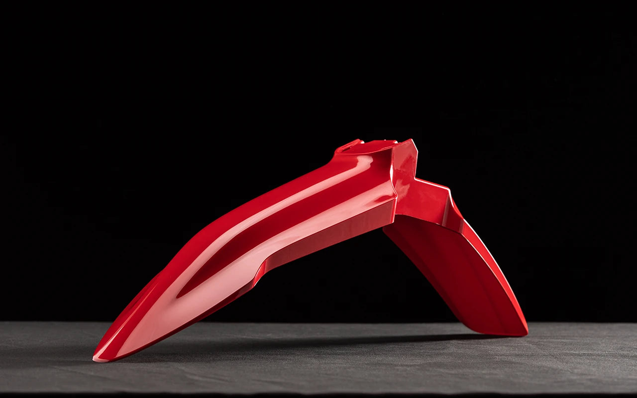 Front fender in stark red for motorcycles, showcasing sleek design and vibrant color.